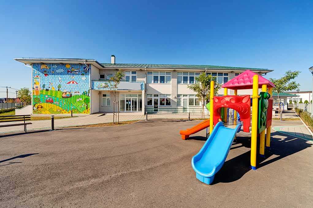 Colorful playground slide in front of a building