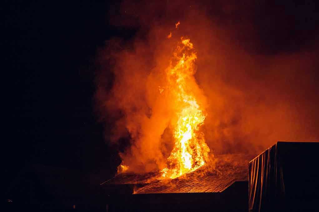 Building engulfed in large flames at night