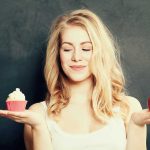 Shocking Link Between Diet and Cancer Risk Woman holding a cupcake and an apple
