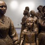 Bronze sculptures of women and children in historical attire