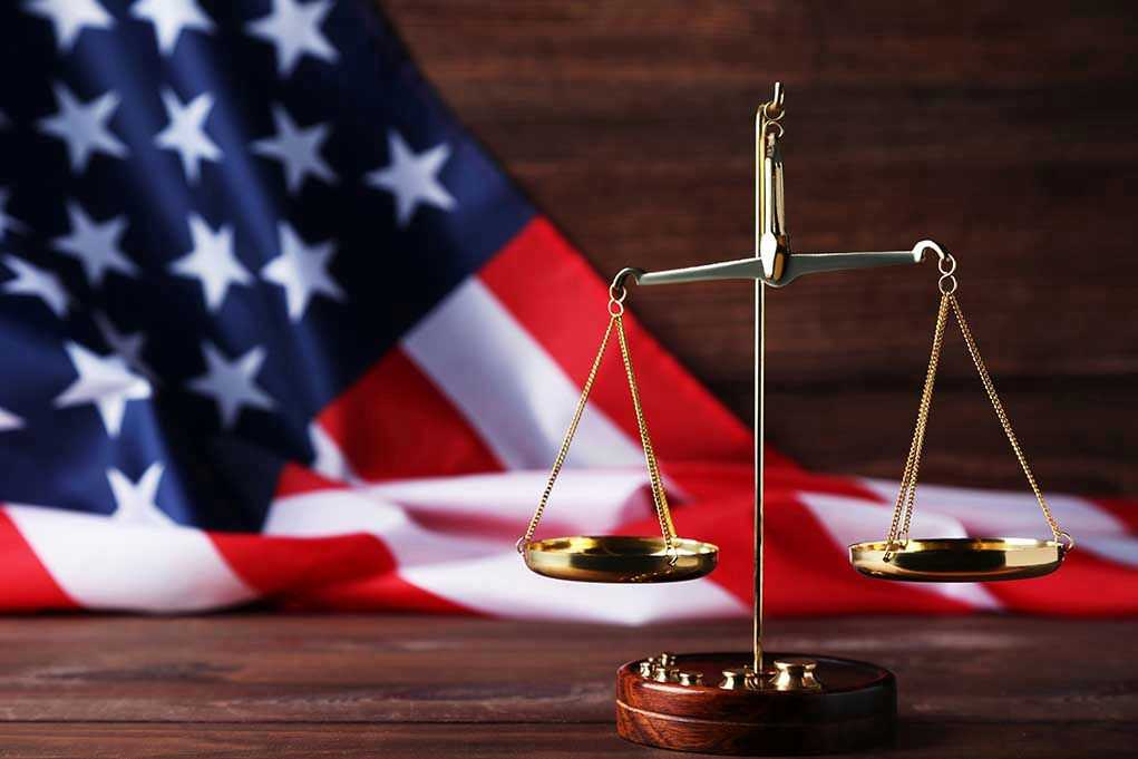 Scales of justice with American flag background