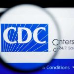 Historic CDC Vaccine Lawsuit: Pediatricians File Suit CDC logo magnified on a screen.