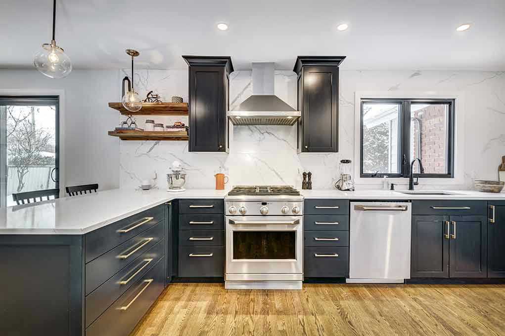 Modern kitchen with black cabinets and stainless appliances.