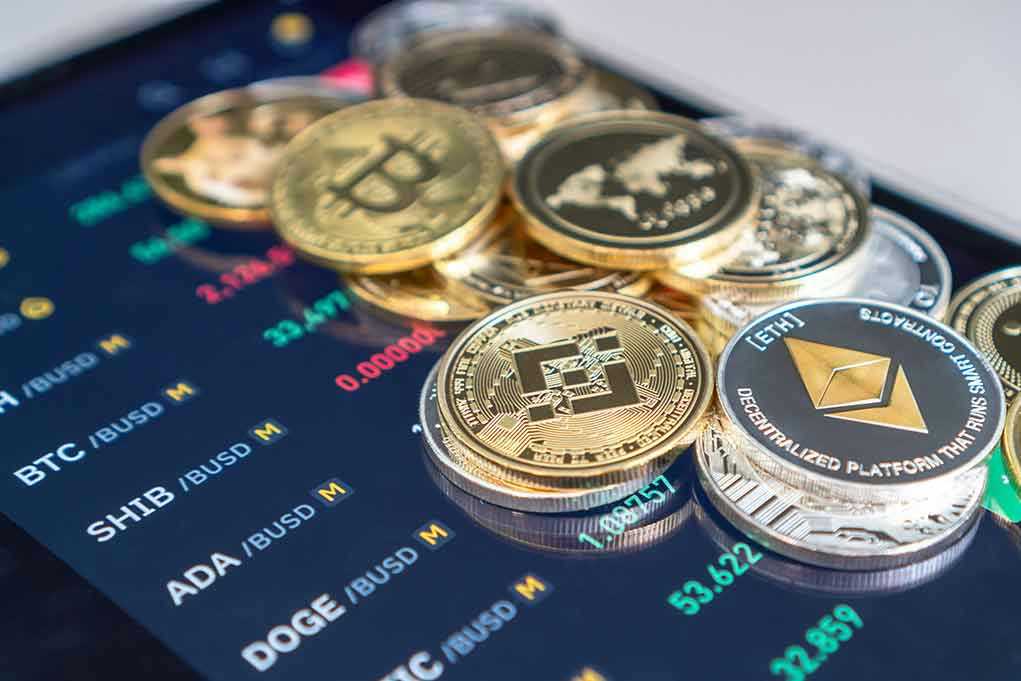 Cryptocurrency coins on a trading screen background