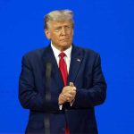 Trump Drops Bombshell on Ukraine War Plans Man in a suit with a blue background.