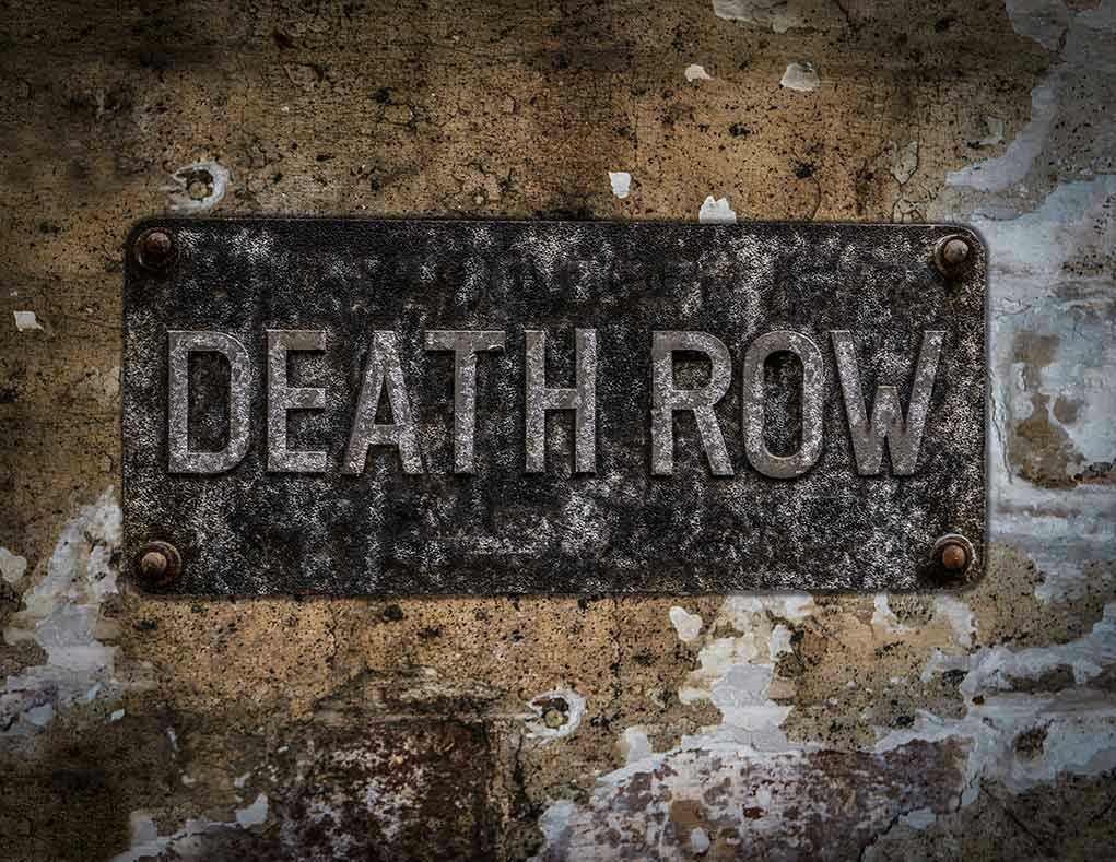 Weathered Death Row sign on aged concrete wall