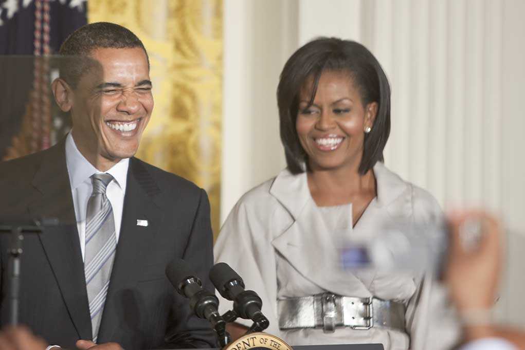 Former President Barack Obama and Michelle Obama smiling at a public event