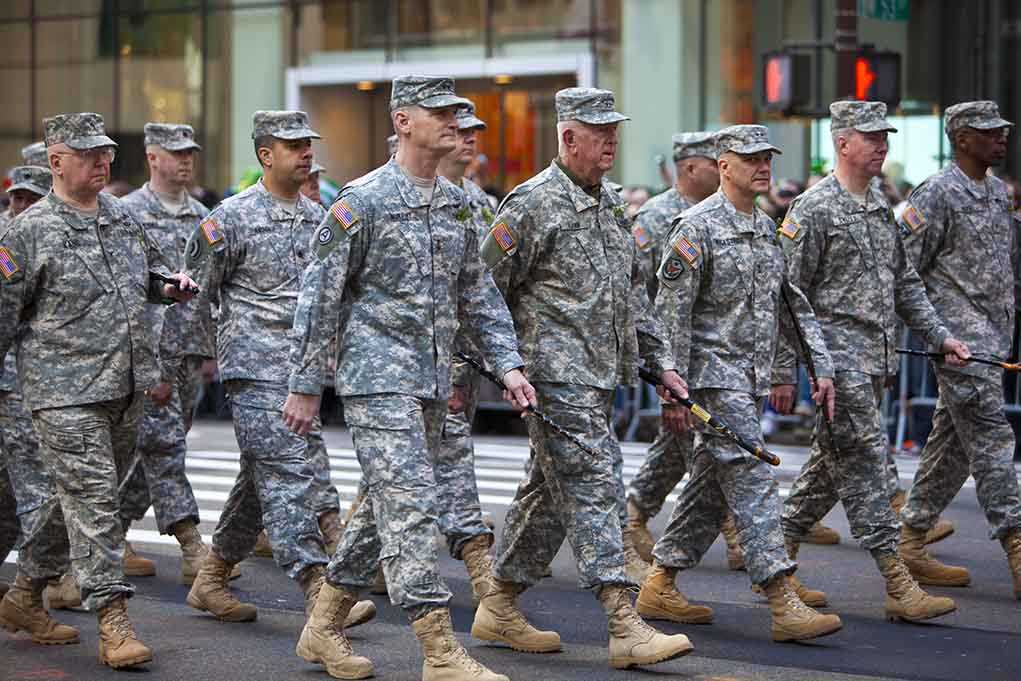 shutterstock_98236508.jpg Group of soldiers marching in a military parade on a city street
