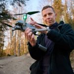 White Supremacist’s DRONE BOMB Plot Exposed Person holding a drone in a forest.