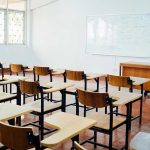 Biggest Union SCANDAL Stuns Education Sector – MILLIONS MISSING! Empty classroom with desks, chairs, and whiteboard.