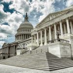 Roberts Sides with Trump – Congress at Odds The U.S. Capitol building with a cloudy sky backdrop