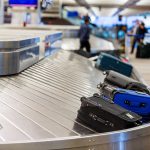 MASSIVE Cyberattack: Flights Grounded Across Europe Luggage on a conveyor belt at an airport baggage claim area