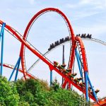 DEATH Strikes Universal’s Flagship Roller Coaster Colorful roller coaster with riders on a sunny day