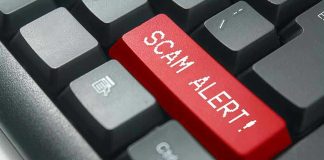 Close-up of keyboard with red SCAM ALERT key.