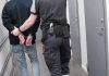 Teen Killer STAGED Brutal Murder Scene Officer escorting handcuffed person down hallway.