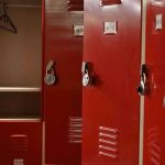 MAJOR WIN — Federal Court BLOCKS School’s Dangerous Policy Red lockers with padlocks, one open with hanger.