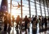Airport Massacre Averted — Family Heroics! Crowd of travelers in airport terminal with airplane outside.