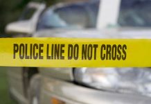 Violent Ambush Rocks Kentucky—Trooper Down! Yellow police tape in front of a car.