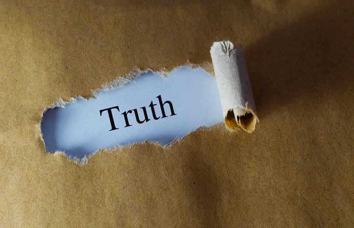 384729706 Ripped paper reveals word truth underneath brown surface