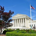 Supreme Court — Trump’s $3 Trillion Tariff Showdown Supreme Court building with American flag and surrounding greenery