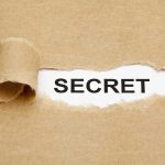 $2 Million CEO Payout BOMBSHELL—Taxpayers FURIOUS A torn piece of brown paper revealing the word SECRET underneath