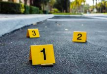 Two Sisters ARRESTED — Three Students DEAD! Crime scene markers on asphalt with bullet casing.