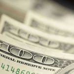 NYC’s Leftist Agenda Drives Firms North Close-up of hundred-dollar bills.