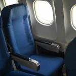 Cramped Seats: Airlines’ Hidden Profit Machine Empty airplane seats next to windows.