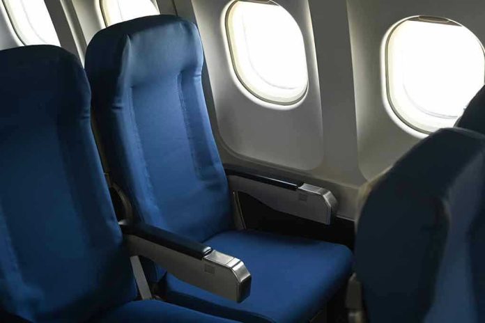 Empty airplane seats next to windows.