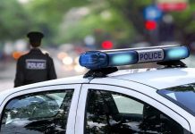 Welfare Check Reveals HORRIFYING Family Crime Scene Police car and officer on a city street.