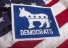 Massive Smuggling Ring Exposed—Democrats Defend Mastermind Democrats logo on American flag background