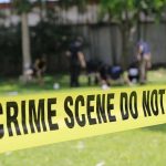 Texas Backyard Horror Unleashed — Chained for Months Yellow crime scene tape blocking grassy area.