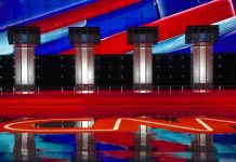 Four debate podiums on a CNN stage background.