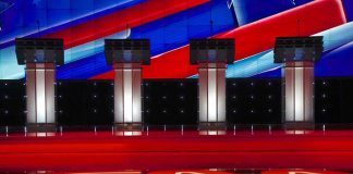 Four debate podiums on a CNN stage background.