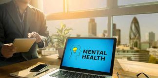 Laptop displaying Mental Health screen in an office.
