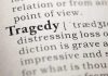 Close-up of the word 'Tragedy' in a dictionary with its definition