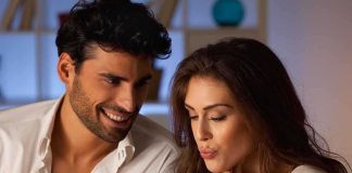 A couple sharing a plate of desserts in a cozy indoor setting