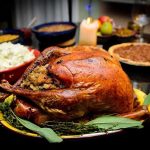 Apple vs Pumpkin: How to HACK Your Dessert A beautifully roasted turkey on a festive table surrounded by side dishes and decorations