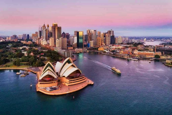 Sydney Opera House and city skyline at sunset.