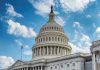 U.S. Capitol building dome under clear blue sky.