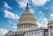 U.S. Capitol building dome under clear blue sky.