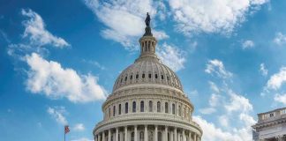 U.S. Capitol building dome under clear blue sky.