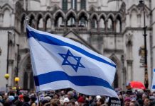 Four Nations BOYCOTT Eurovision — Israel Triggers Walkout Israeli flag at a crowded outdoor event.