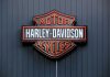 122-Year American Legend COLLAPSES – Economy Warning Harley-Davidson Motor Cycles logo on dark wall.