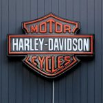 Harley-Davidson Motor Cycles logo on dark wall.