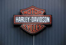 Harley-Davidson Motor Cycles logo on dark wall.
