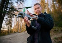 Cheap Kamikaze Drone Upends U.S. War Playbook Person holding a drone in a forest.