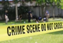 Judge Exposes Chilling “Put Him Down” Plot Yellow crime scene tape blocking grassy area.