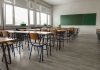 ‘Teacher of the Year’ SHOCKER Caught on Camera Empty classroom with desks, chairs, windows, and chalkboard.