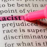 Racist highlighted in pink marker in a book.